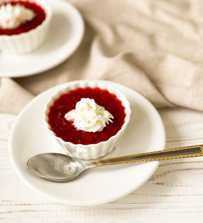 delicious dessert strawberry mousse with cream on a wooden table