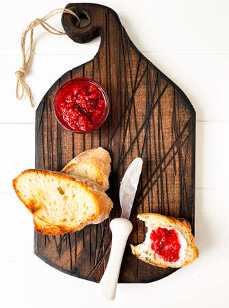 toast, with raspberries on a wooden tableの写真素材
