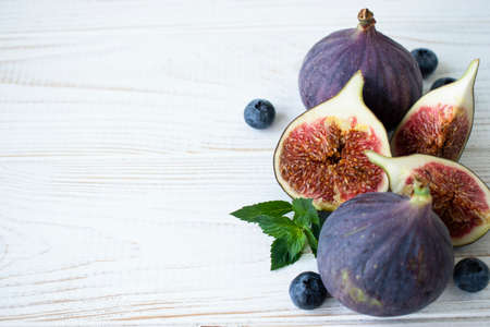 figs and blueberries on a wooden tableの写真素材