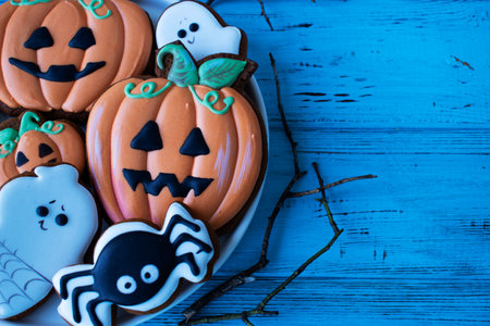 pumpkin gingerbread for halloween on blue wooden tableの写真素材