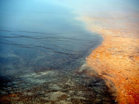 Natural design in the ground created by minerals & algae in Yellowstone National Park, United Statesの写真素材