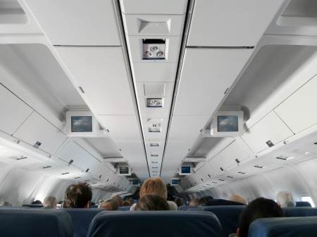Airplane interior - people sitting on seatsの写真素材