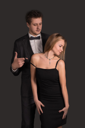the loving couple in elegant clothes embracesの写真素材
