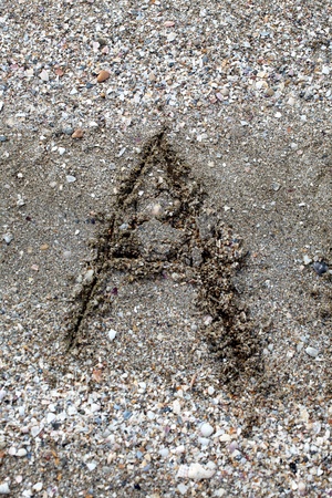 Collection of  handwritten English alphabet in the sand exotic beach sea. education,letter,text,vacation or tourismの写真素材