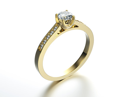 Golden Engagement Ring with Diamond. Jewelry backgroundの写真素材