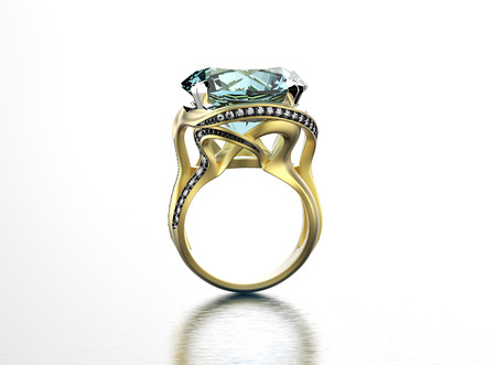 Golden Engagement Ring with aquamarine. Jewelry backgroundの写真素材