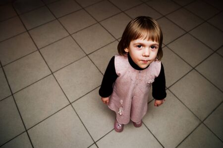 The little girl smiling with interest is looking upの写真素材