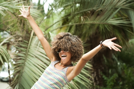 A beautiful young woman in a wig of curly hairの写真素材
