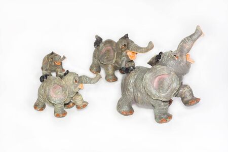 Four going elephants from ceramics on a white backgroundの写真素材