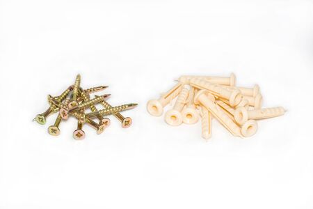 Small groups of screws and dowels on a white background