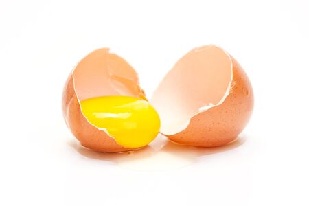 The broken chicken egg is isolated on a white backgroundの写真素材