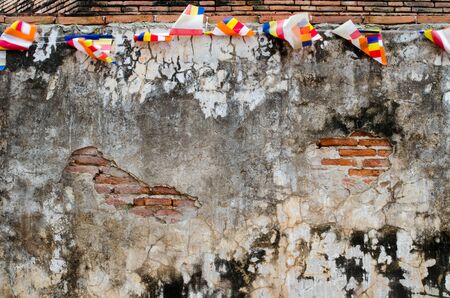 Red old Brick Wall with Colorful Flags, Damaged Backgroundの写真素材