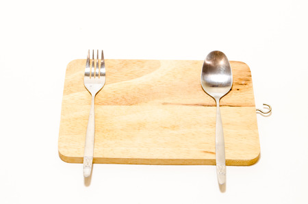 Wooden Chopping Board with Spoon and Fork on White Background.の写真素材