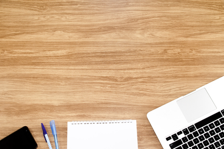 The Top View of Office Table with Notebook on The Wooden Background.の写真素材