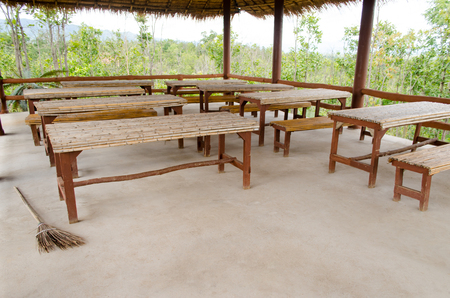 A Empty Classroom at a Rural Vintage School in a Small Village. The Open-air School with Straw Roof and Wooden Desk.の写真素材