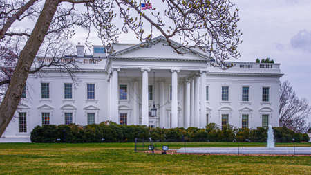 View of the main entrance to the White House Presidential residence in Washington DC with fountain and iron security fence on the grounds in foregroundのeditorial素材