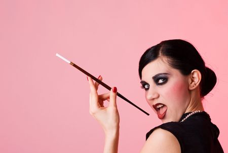 Retro styled flirting girl with cigaretteの写真素材