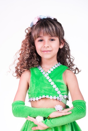 Beautiful little girl dancing in green dressの写真素材
