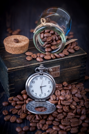 Coffee and vintage watch on a chainの写真素材