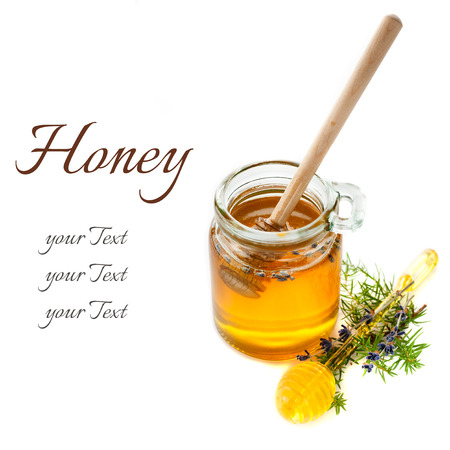 Glass jars of honey and a spoon of honeyの写真素材
