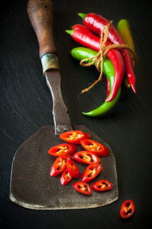Hot chili and antique knife for chopping herbsの写真素材