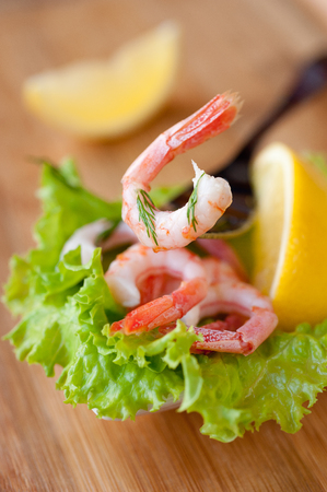 Shrimp, lemon and green saladの写真素材