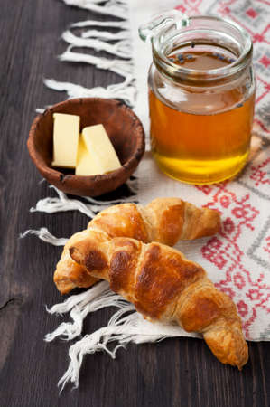 Croissants with honey in a rustic styleの写真素材
