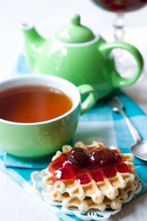 Wafers with strawberry jam and teaの写真素材