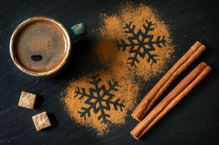 Cinnamon and a cup of coffee on a chalkboardの写真素材