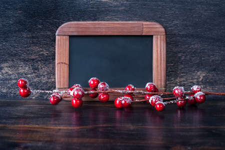 Christmas concept: the chalk board and decorations on old wooden backgroundの写真素材