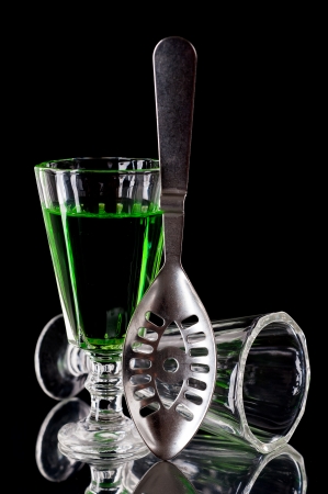 Glass of absinthe and absinthe spoonの写真素材