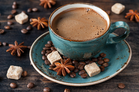 Ð¡offee cup with spices on dark wooden backgroundの写真素材
