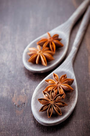 Star anise in old wooden spoonsの写真素材