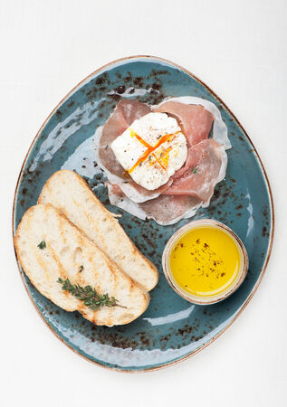 Prosciutto ham,  poached egg, chiabatta. Breakfast の写真素材