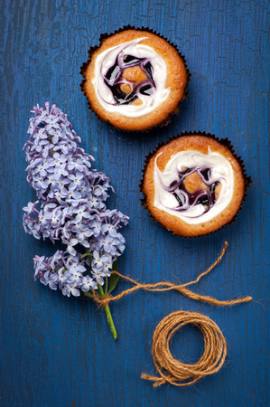 Cakes with berries and cream on blue background の写真素材