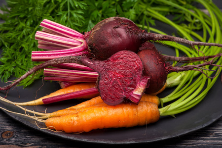 Beets and carrots with leaves closeupの写真素材