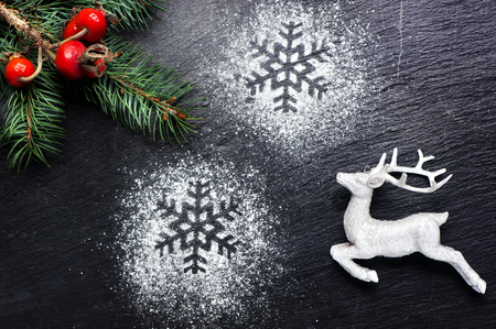Christmas festive background with deer and snowflakesの写真素材