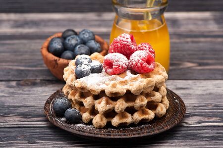 Waffles with berries and honeyの写真素材