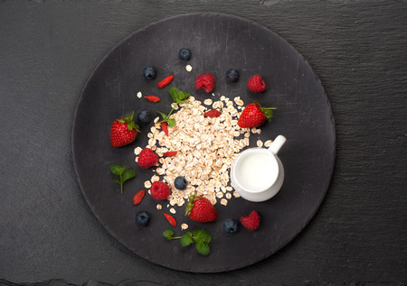 Oatmeal, milk and berries. Healthy breakfast. top viewの写真素材