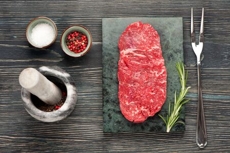 Raw steakÂ RibeyeÂ entrecote on dark wooden backgroundの写真素材