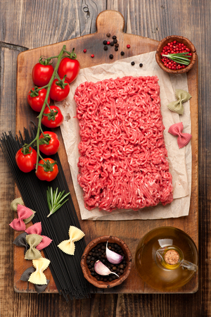 Italian food ingredients: minced beef, pasta, spaghetti, tomato and spicesの写真素材