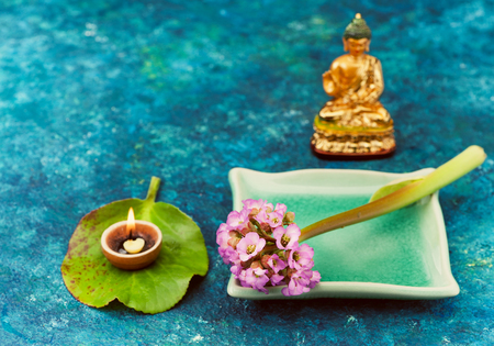Spa composition with pink flowers and Buddha statueの写真素材