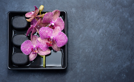 Spa background. Massage stones and orchid flowersの写真素材