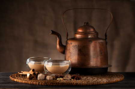 masala chai, spices and spicy on a wooden tableの写真素材