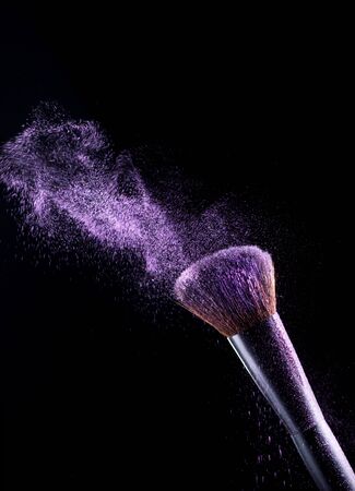 Brush make-up and eyeshadow on a black backgroundの写真素材