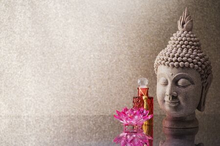 Buddha head statue  and orchid flower decoration and copy space for textの写真素材