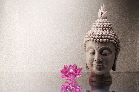 Buddha head statue and Orchid flower decoration and copy space for textの写真素材