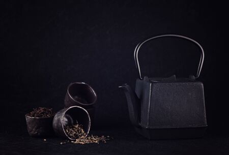 Tea set with a different tea. Cast iron kettle and cupsの写真素材