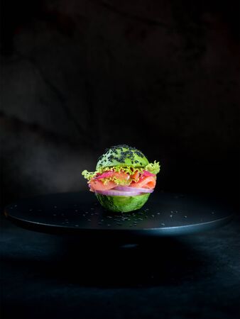 Avocado burger with salmon and vegetables. healthy vegan food conceptの写真素材