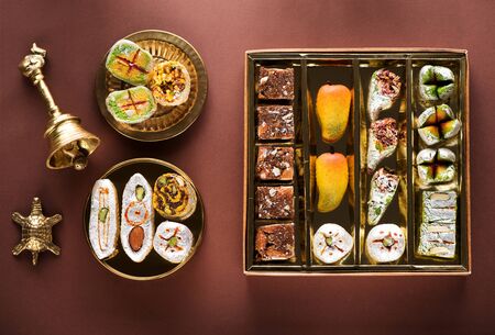 Indian sweets and Mithai in a box and a plate. Diwali festival concept, flat lay, top viewの写真素材